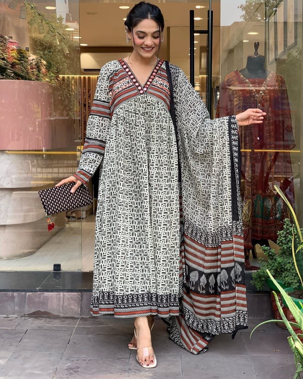 WhatsApp Image 2024-12-24 at 12.40.11 PM Gown- Cotton 60-60 Suit Cum Gown Set which is beautifully decorated with mirror lace detailing in neck. It is paired with matching dupatta and pant.